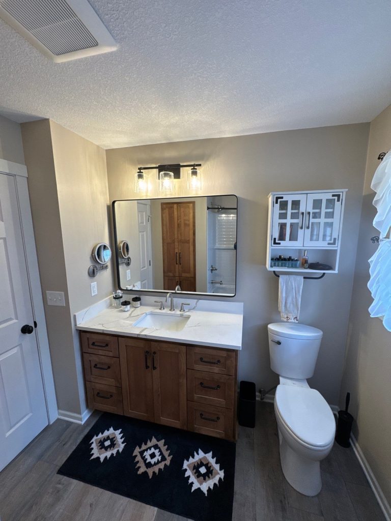 Modern bathroom with wooden vanity and white countertop