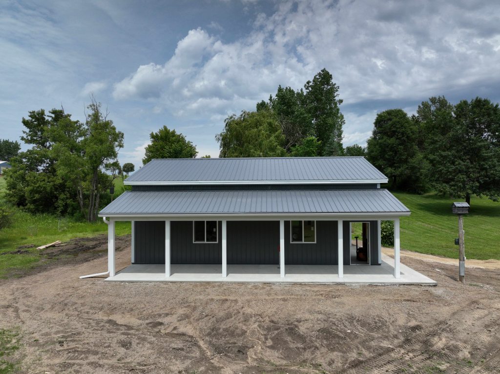 Modern barn-style home with metal roof and porch