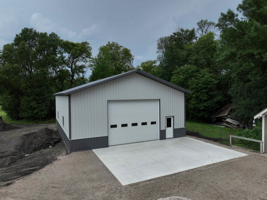 New metal garage with large door and driveway