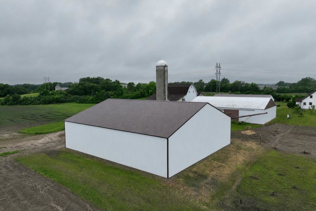 White barns and silo on rural farmland