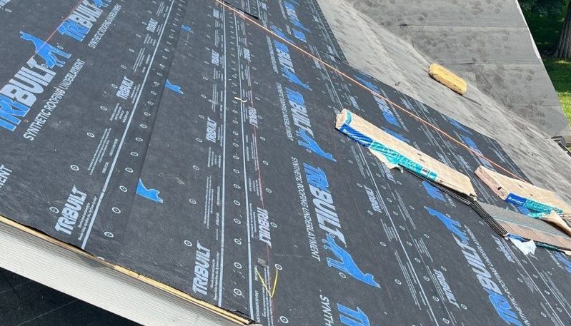 Synthetic roofing underlayment installed on sloped roof